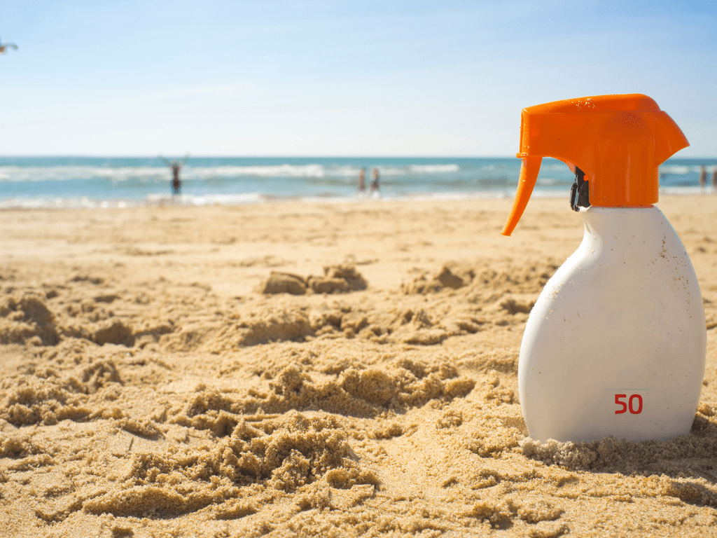 bottle of sunscreen SPF 50 on a beach